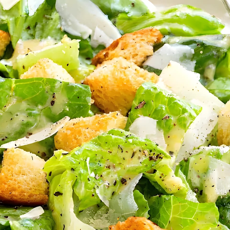 Close-up of a fresh Caesar salad with crisp romaine lettuce, croutons, and Parmesan cheese.